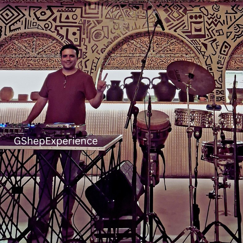 GShep behind the decks with live percussion